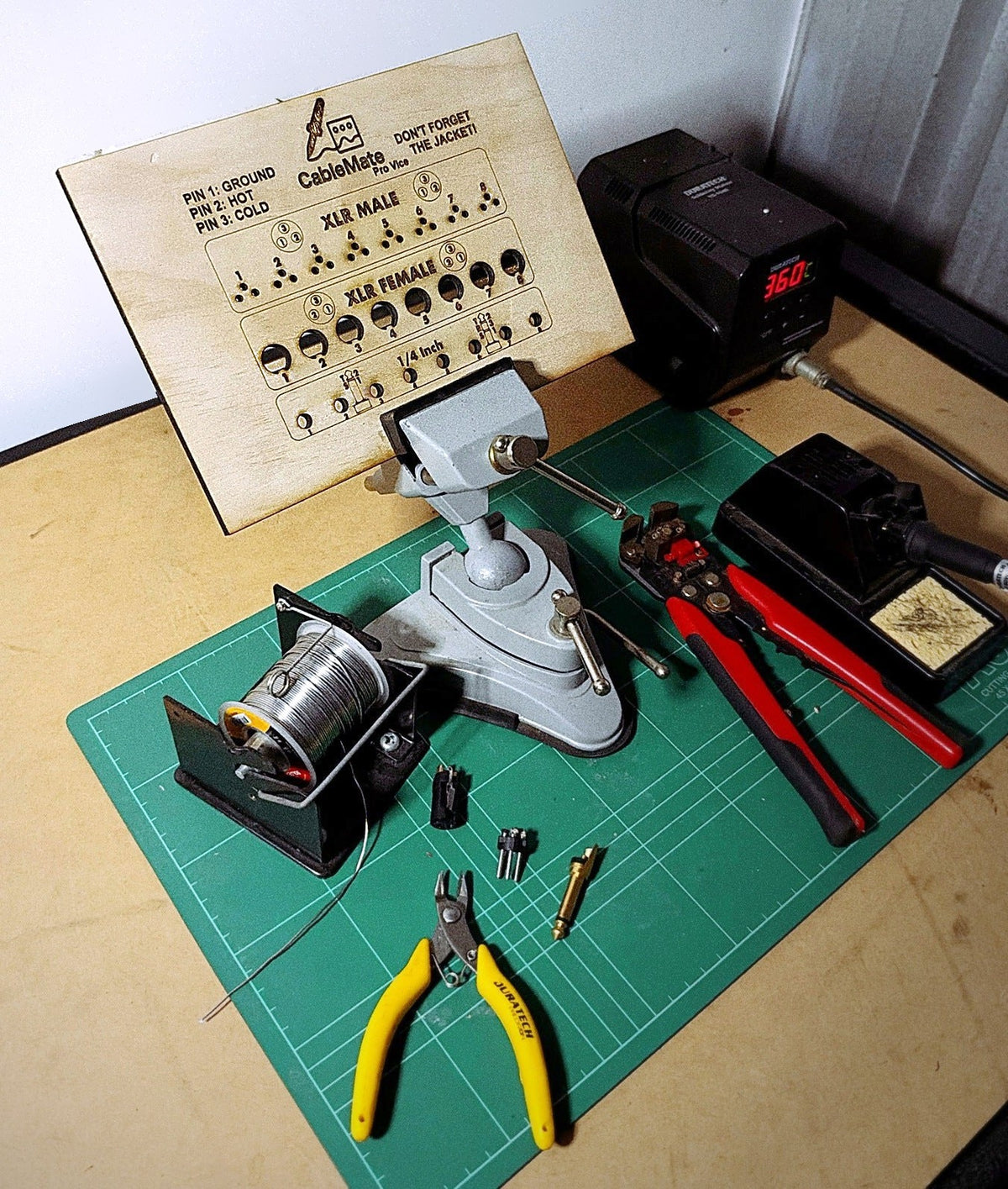 CableMate Pro vise-mount soldering jig clamped in a bench vise